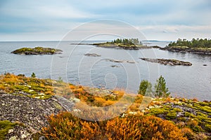 Beautiful Lake Rock Islands Landscape Red Rusty Grass and Green Moss Autumn Scenery Heavy Blue Sky