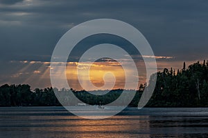 Beautiful lake sunset with shafts of light reflecting off the water