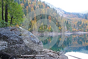 Beautiful lake surrounded by mountains and forests in autumn. Malaya Ritsa, Abkhazia