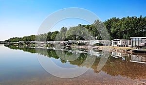 Beautiful lakeside vacation homes at calm idyllic lake in dutch holiday park - Arcen, Limburg, Netherlands