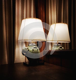 Beautiful lamp with electric light and reflection in the mirror, look beautiful and vintage.