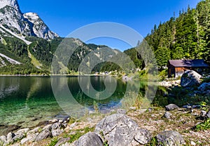 Beautiful landscape of alpine lake with crystal clear green water and mountains in background, Gosausee, Austria