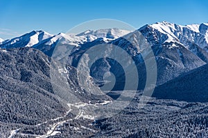 Beautiful landscape of the Arkhyz ski resort with mountains, snow, forest on sunny winter day. Caucasus Mountains, Russia