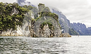 Beautiful landscape with background mountains trees and mist and a river sky and natural attractions in front at dam Thailand.