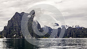 Beautiful landscape with background mountains trees and mist and a river sky and natural attractions in front at dam Thailand.