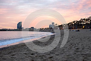 Beautiful landscape of the beach in Barcelona city on sunset