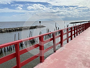 Beautiful landscape. Beautiful red long wooden bridge in Samut Sakhon province, Thailand. It is a dolphin watching spot.