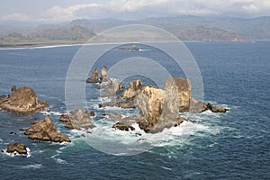 Beautiful landscape of big rocks in the middle of the ocean at Teluk Cinta in Jember, Indonesia.