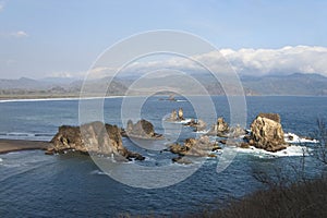 Beautiful landscape of big rocks in the middle of the ocean at Teluk Cinta in Jember, Indonesia.