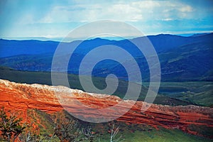 Glowing red rocks on Highway 296 near Cody, Wyoming photo