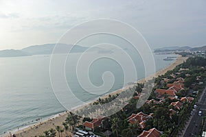 Beautiful landscape with blue sea, houses and tree along the beach in the beach city