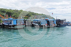 Beautiful landscape with blue sky, mountain, sea and blue boats in the beach city