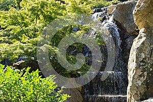 Beautiful landscape with cascade waterfall with large stones wall in park Aivazovsky, Partenit