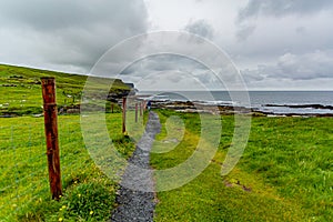 Beautiful landscape of the coast and a rural footpath in of the coastal route walk from Doolin to the Cliffs of Mohe