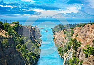 Beautiful landscape of the Corinth Canal in a bright sunny day against a blue sky with dramatic clouds