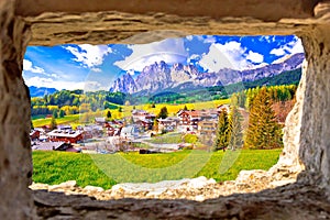 Beautiful landscape of Cortina d` Ampezzo in Dolomites Alps view through stone window photo