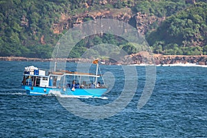 Asian fishermen in motor boat photo