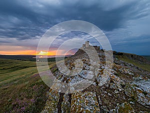 Beautiful landscape and a dramatic sunset sky with storm clouds over Enisala old stronghold citadel