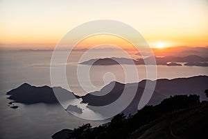 Beautiful landscape from a drone on the sea, mountains at sunset.