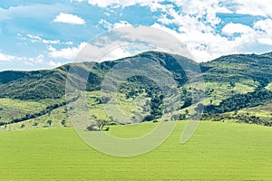 Beautiful landscape of a farm field near the hills
