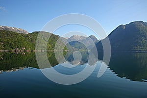 Beautiful landscape in the fjord, with reflections of the mountains in the water. Rosendal, Hardangerfjord, Norway.