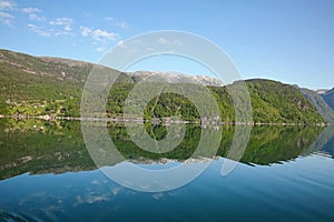 Beautiful landscape in the fjord, with reflections of the mountains in the water. Rosendal, Hardangerfjord, Norway.