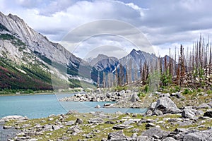 Beautiful landscape of a glacial Medicine Lake, Jasper National Park, Canada. Turquoise glacial water and majestic Rocky