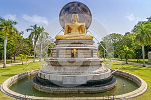 Beautiful landscape and golden buddha statue in Viharamahadevi Park, Colombo, Sri Lanka photo
