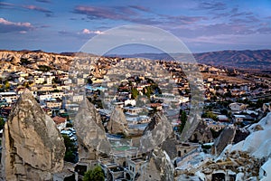 Beautiful landscape of Goreme on sunrise.Cappadocia.Turkey. View of rock formations fairy chimneys, hotels and houses at the cave.