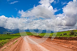 Beautiful landscape of gravel road, fields, meadows and mountains in Peru, South America