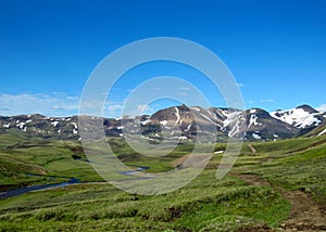 Beautiful landscape of green Hvanngil valley and rhyolite mountains covered with snow, Laugavegur Trail, Highland of Iceland