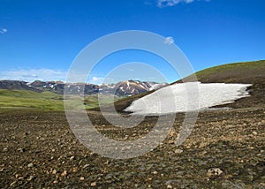 Beautiful landscape of green Hvanngil valley and rhyolite mountains covered with snow, Laugavegur Trail, Highland of Iceland