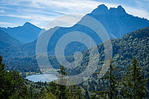 Beautiful landscape of green mountains and a lake in Fussen, Germany.