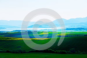 Beautiful landscape, green and yellow meadow and lake with mountain in background. Slovakia, Central Europe.