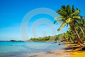 Beautiful landscape of Hon Thom beach, Phu Quoc island, Vietnam, Asia with tourist, chairs and umbrella. White sand and coco palms