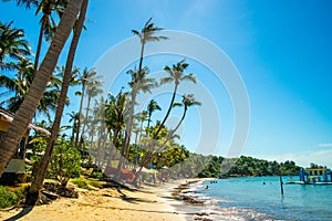 Beautiful landscape of Hon Thom beach, Phu Quoc island, Vietnam, Asia with tourist, chairs and umbrella. White sand and coco palms