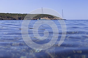 beautiful landscape in Ibiza of blue ocean in a sunny day with boats in the horizon. Summer and holidays concept