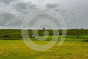 Beautiful landscape of the Irish countryside with the castle Doonagore in the background in the village of Doolin