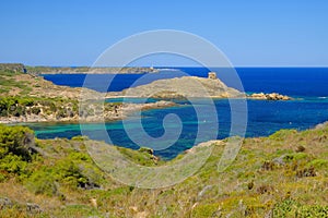 View on the light house Cape Favaritx and the old watch tower Es Colomar in Es Grau on Menorca photo