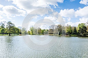 Beautiful landscape with lake and green trees in April in front of the City hall of Hannover, Germany