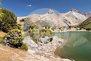 Beautiful landscape of lake Kulikalon among rocky mountains Fann, Tajikistan. Hiking on mountains Fan