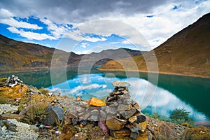 Beautiful landscape with lake, mountain and pile of stone in Tibet