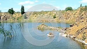 Beautiful landscape of lake in summer with basalt rocks, stones, calm water