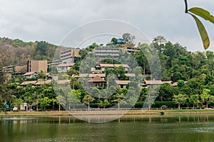 Beautiful landscape with lake, trees and huge hotel building in Phuket. Thailand.