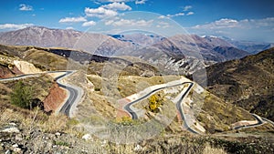 Beautiful landscape with long rural road leading through hills