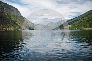beautiful landscape with majestic mountains and calm water of Aurlandsfjord Flam
