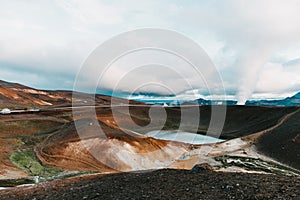 beautiful landscape with majestic volcanic lake and steam from hot springs,