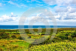 Beautiful landscape of a meadow with green grass in the Burren with the sea in the background