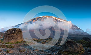 Beautiful landscape of Mount Kilimanjaro covered in fluffy clouds