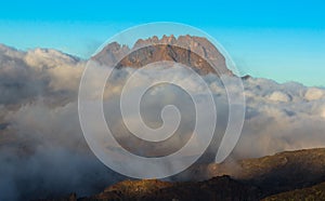 Beautiful landscape of Mount Kilimanjaro covered in fluffy clouds